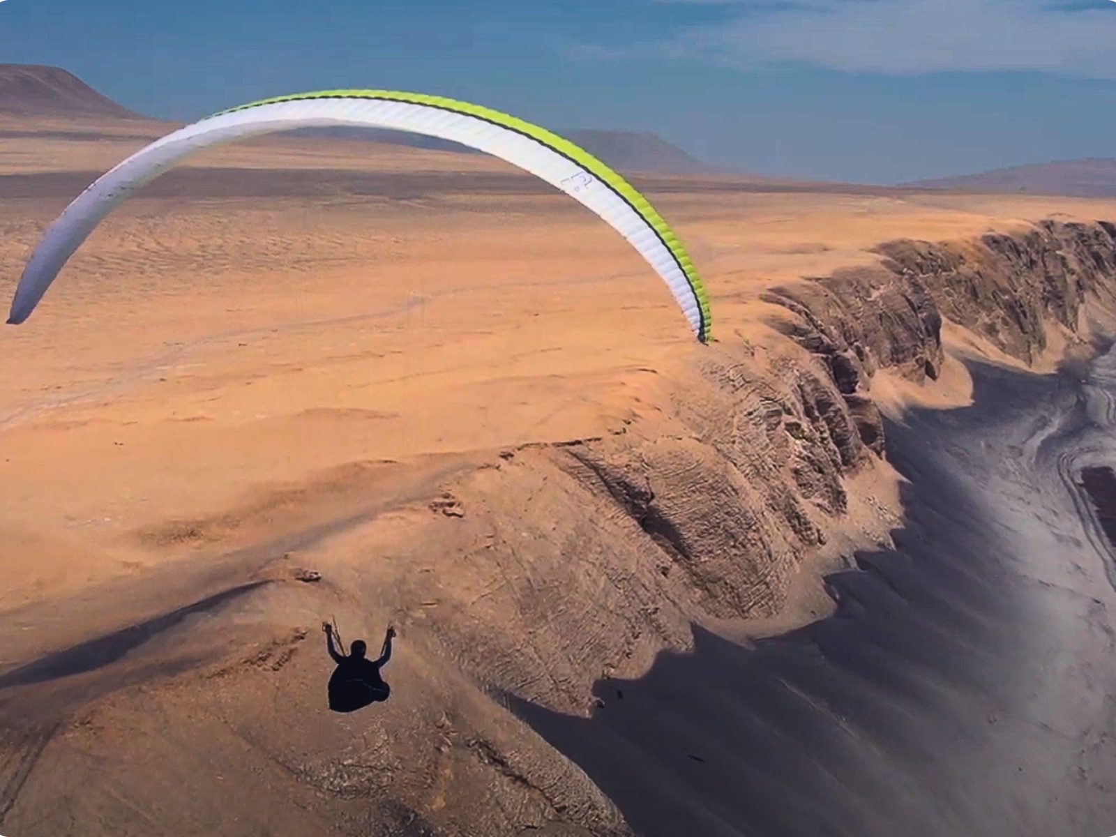 Paraglider above the Peruvian desert coastline